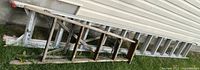 Aluminum extension ladder with wooden ladder on top, side view