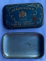 Closed tin showing graphics and wear