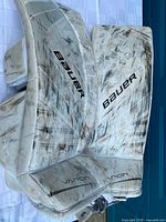 Front view of both Bauer Vapor junior goalie pads showing graphics and puck marks