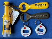 Group of five branded bottle openers including Corona Extra, Molson's and Molson Canadian