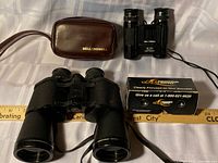 Overview of three binoculars, Bell & Howell case, promotional mini binocular box