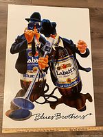 Full view of poster showing both animated Blues Brothers beer bottles and title