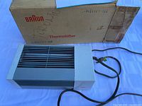 Heater with power cord beside original Braun Thermolüfter box