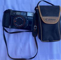 Front view of Canon AF35M II camera with strap and pouch