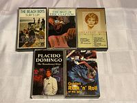 Front view of all five cassette tapes with artwork visible