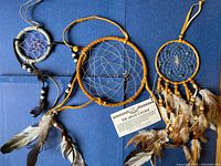 Front view of all three dreamcatchers with informational card