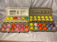 Four cartons holding 48 coloured golf balls