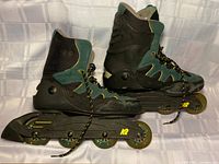 Side view of both skates showing boots, frames and wheels
