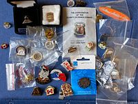 Group shot of all pins on blue background, showing quantity and variety