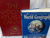 Front covers of both large geography books