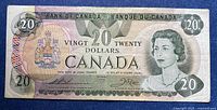 Obverse of the 1979 Canadian $20 bill showing serial number, portrait, denomination and wear