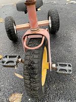 Front view showing tire, pedals, mudguard