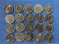 20 assorted Canadian commemorative quarters laid out on blue background