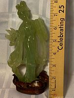 full statue beside ruler showing 8 in height on wooden stand