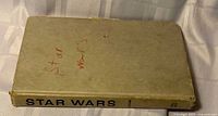 Closed tan hardcover showing spine title STAR WARS, red marker writing on cover