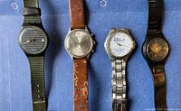 Front view of four wristwatches aligned