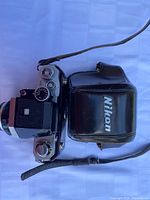 Top view Nikon F camera with attached case and strap