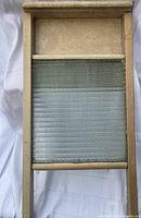 Front view of wooden framed washboard with ribbed glass panel