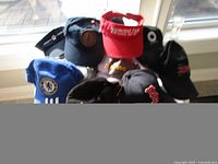 Group shot of assorted logo hats from window side