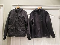 Front view of both jackets hanging, showing overall style and details