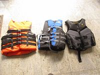 All three life vests side by side on floor