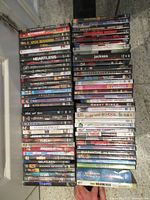 Entire lot – four vertical stacks of about 70 DVD cases