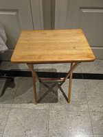 Front view of folded-out wooden TV table