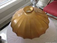 Side view showing ribbed fluted design and top opening