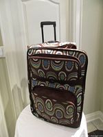 Front view of patterned Wild Terrain rolling suitcase