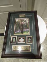 Full view of framed Mike Weir autographed display showing photo, plaques, trophies, frame