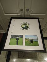 Full view of framed Pebble Beach pin flag and photos