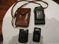 Group shot showing Kodak camera, leather case, Nokia phone, Blackberry case
