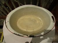 Interior of oval enamel wash tub showing wear