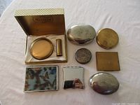 Group shot of all compacts and lipstick case