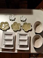 Group of 9 pieces: two white leaf dishes, three pale green flower dishes, two white double-compartment sauce dishes, two off-white oval bowls