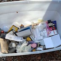 Large plastic bin filled with packaged and loose bulbs