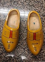 Top view of both clogs showing painted design and interior stamps