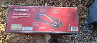 Retail box front and side panels displaying Husky 2-way adjustable oscillating sprinkler
