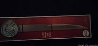 Full view of pewter letter opener-ruler in original red box