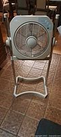 Front view of Air Innovations adjustable height box fan on stand