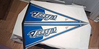Two Toronto Blue Jays pennants front view on table