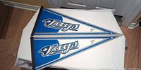 Front view of two identical Toronto Blue Jays pennants