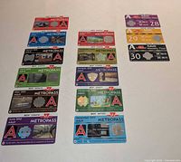 All fourteen 2013 TTC Metropasses and weekly passes laid out on flat surface