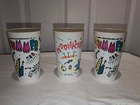 Front view of three McDonald’s Coca-Cola Summer tumblers displaying main logo graphics