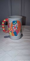 Front view showing 3-D clown graphic and beaded handle