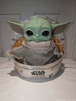 Front view of Grogu plush in original box