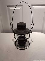 Front view of the E.T. Wright kerosene lantern showing globe, cage and handle