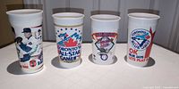 Front view of four Toronto Blue Jays plastic cups
