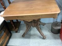 Full view of antique table showing pedestal base and legs