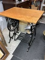 Table front angle showing cast iron base and wood top